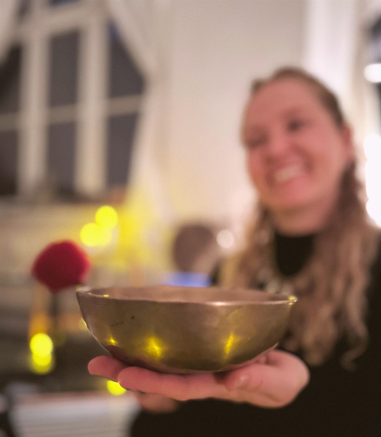 Anna Burger holding a singing bowl